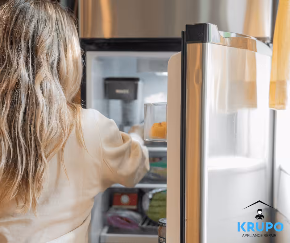woman opening a luxury ice maker, linking to a blog about common Viking ice maker problems and solutions